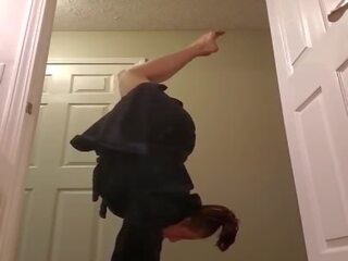 Fit mistress doing handstands and showing off her big tits